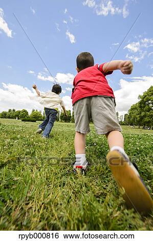 Young Japanese kids playing in a park View Large Photo Image Stock Photograph - Young Japanese kids playing in a park. Fotosearch