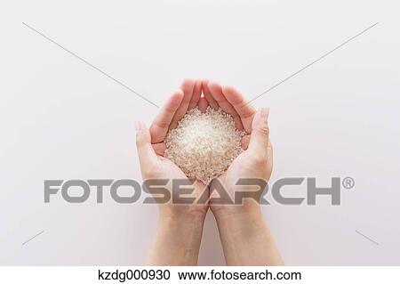 Young Japanese woman holding rice in her hands View Large Photo Image Stock Image - Young Japanese woman holding rice in her hands. Fotosearch