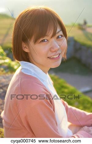 Young Japanese woman in the countryside looking at camera View Large Photo Image Stock Photography - Young Japanese woman in the countryside looking at camera. Fotosearch