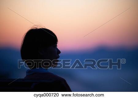 Young Japanese woman sitting on a bench in the countryside View Large Photo Image Stock Image - Young Japanese woman sitting on a bench in the countryside. Fotosearch