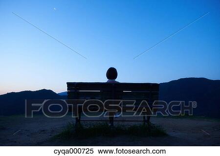 Young Japanese woman sitting on a bench in the countryside View Large Photo Image Stock Photography - Young Japanese woman sitting on a bench in the countryside. Fotosearch