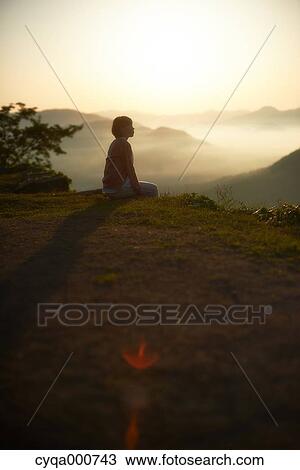 Young Japanese woman sitting on grass in the countryside View Large Photo Image Stock Image - Young Japanese woman sitting on grass in the countryside. Fotosearch