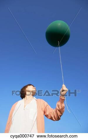 Young Japanese woman with green balloon in the countryside View Large Photo Image Stock Photo - Young Japanese woman with green balloon in the countryside. Fotosearch