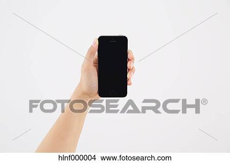 Young woman holding smartphone View Large Photo Image Picture - Young woman holding smartphone. Fotosearch