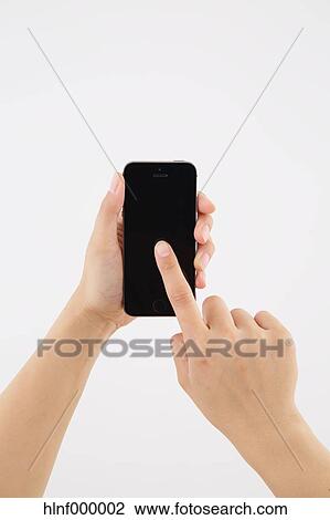 Young woman holding smartphone View Large Photo Image Stock Image - Young woman holding smartphone. Fotosearch