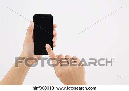 Young woman holding smartphone View Large Photo Image Stock Image - Young woman holding smartphone. Fotosearch
