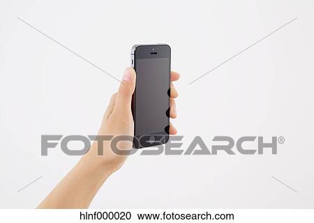 Young woman holding smartphone View Large Photo Image Stock Image - Young woman holding smartphone. Fotosearch