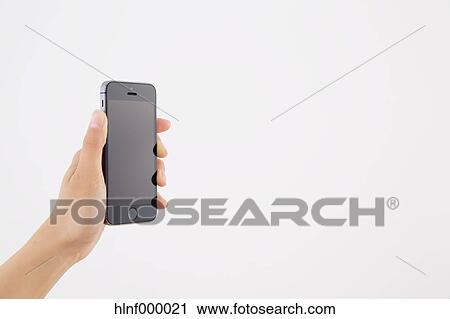 Young woman holding smartphone View Large Photo Image Stock Image - Young woman holding smartphone. Fotosearch