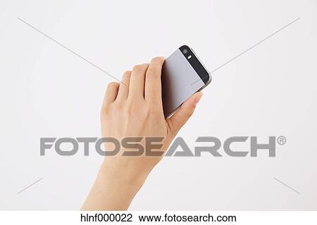 Young woman holding smartphone View Large Photo Image Stock Image - Young woman holding smartphone. Fotosearch