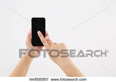 Stock Photo - Young woman holding smartphone. Fotosearch
