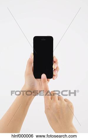 Stock Photograph - Young woman holding smartphone. Fotosearch