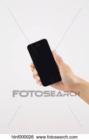 Young woman holding smartphone View Large Photo Image Stock Photograph - Young woman holding smartphone. Fotosearch