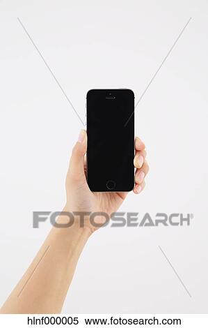 Young woman holding smartphone View Large Photo Image Stock Photography - Young woman holding smartphone. Fotosearch