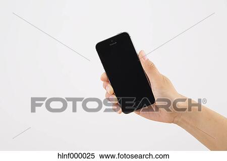 Stock Photography - Young woman holding smartphone. Fotosearch
