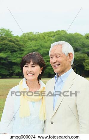Picture - Senior adult Japanese couple in a park. Fotosearch