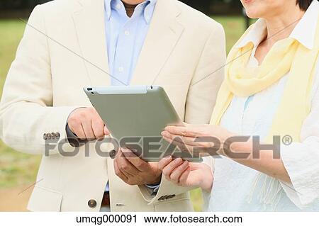 Senior adult Japanese couple in a park View Large Photo Image Stock Image - Senior adult Japanese couple in a park. Fotosearch
