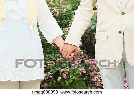 Stock Photo - Senior adult Japanese couple in a park. Fotosearch