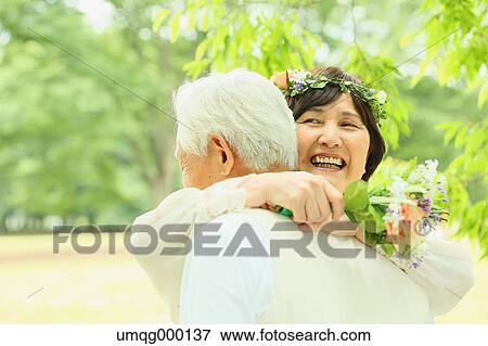 Stock Photo - Senior adult Japanese couple in a park. Fotosearch