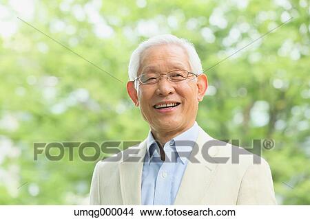 Picture - Senior adult Japanese man in a park. Fotosearch