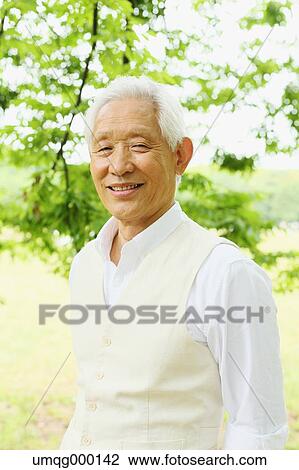 Stock Image - Senior adult Japanese man in a park. Fotosearch