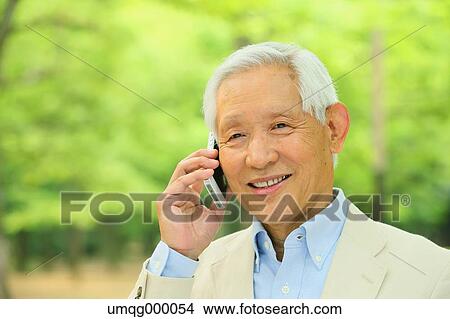 Senior adult Japanese man with smartphone in a park View Large Photo Image Picture - Senior adult Japanese man with smartphone in a park. Fotosearch