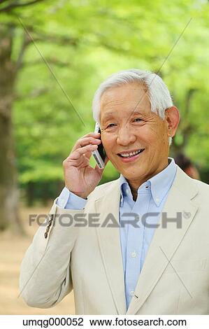 Senior adult Japanese man with smartphone in a park View Large Photo Image Stock Image - Senior adult Japanese man with smartphone in a park. Fotosearch