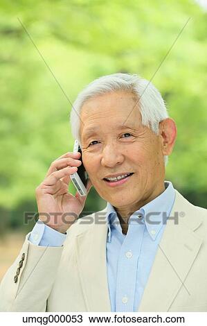 Senior adult Japanese man with smartphone in a park View Large Photo Image Stock Image - Senior adult Japanese man with smartphone in a park. Fotosearch