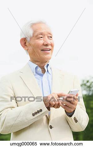 Senior adult Japanese man with smartphone in a park View Large Photo Image Stock Photography - Senior adult Japanese man with smartphone in a park. Fotosearch