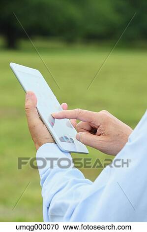 Senior adult Japanese man with tablet in a park View Large Photo Image Stock Image - Senior adult Japanese man with tablet in a park. Fotosearch