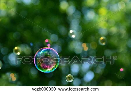 Soap bubbles in a park View Large Photo Image Stock Image - Soap bubbles in a park. Fotosearch