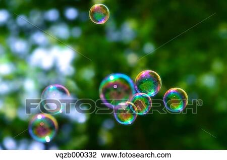 Soap bubbles in a park View Large Photo Image Stock Image - Soap bubbles in a park. Fotosearch