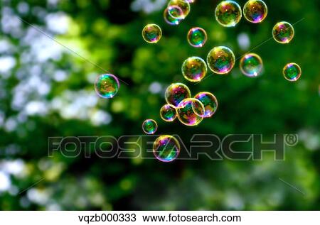 Stock Image - Soap bubbles in a park. Fotosearch