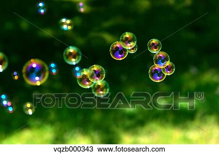 Soap bubbles in a park View Large Photo Image Stock Image - Soap bubbles in a park. Fotosearch