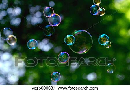 Soap bubbles in a park View Large Photo Image Stock Photo - Soap bubbles in a park. Fotosearch