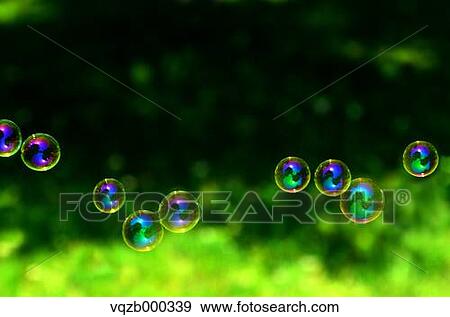 Soap bubbles in a park View Large Photo Image Stock Photo - Soap bubbles in a park. Fotosearch