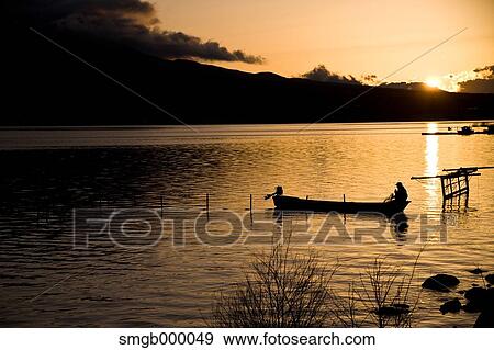 Boat at the lake at sunset View Large Photo Image Stock Photo - Boat at the lake at sunset. Fotosearch