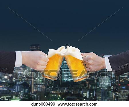 Businessmen toasting with draft beer View Large Photo Image Stock Photo - Businessmen toasting with draft beer. Fotosearch