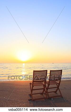 Picture - Chairs At The Beach At Sunset. Fotosearch