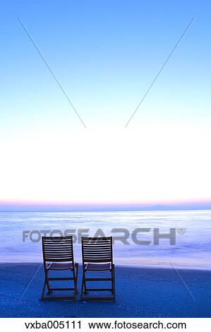 Chairs At The Beach At Sunset View Large Photo Image Stock Image - Chairs At The Beach At Sunset. Fotosearch