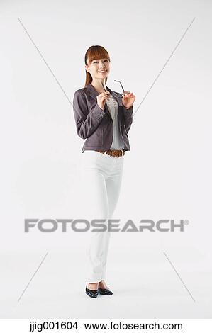 Full length portrait of Japanese young businesswoman against white background View Large Photo Image Picture - Full length portrait of Japanese young businesswoman against white background. Fotosearch