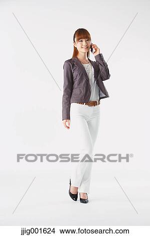 Picture - Full length portrait of Japanese young businesswoman against white background. Fotosearch