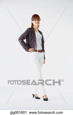 Stock Image - Full length portrait of Japanese young businesswoman against white background. Fotosearch