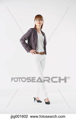 Stock Image - Full length portrait of Japanese young businesswoman against white background. Fotosearch
