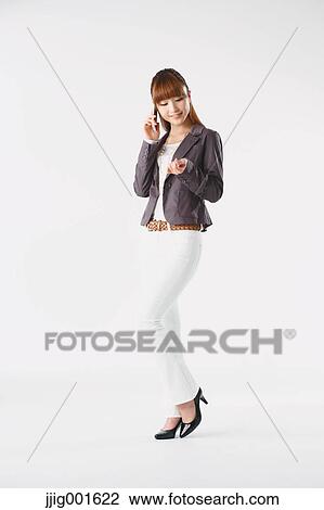 Full length portrait of Japanese young businesswoman against white background View Large Photo Image Stock Image - Full length portrait of Japanese young businesswoman against white background. Fotosearch