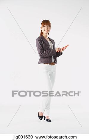Full length portrait of Japanese young businesswoman against white background View Large Photo Image Stock Image - Full length portrait of Japanese young businesswoman against white background. Fotosearch