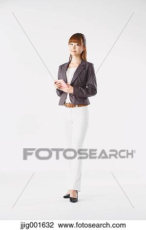 Full length portrait of Japanese young businesswoman against white background View Large Photo Image Stock Image - Full length portrait of Japanese young businesswoman against white background. Fotosearch