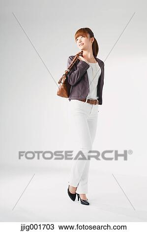 Full length portrait of Japanese young businesswoman against white background View Large Photo Image Stock Image - Full length portrait of Japanese young businesswoman against white background. Fotosearch