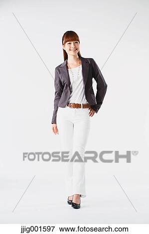 Stock Photo - Full length portrait of Japanese young businesswoman against white background. Fotosearch