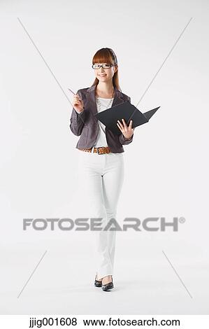 Stock Photo - Full length portrait of Japanese young businesswoman against white background. Fotosearch