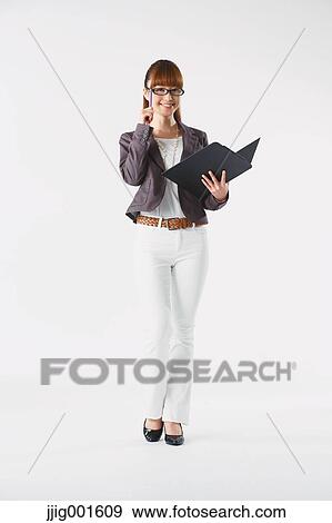 Stock Photo - Full length portrait of Japanese young businesswoman against white background. Fotosearch